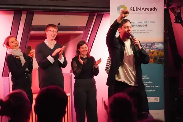 Poetry slam performers on stage at the KLIMAready Slam